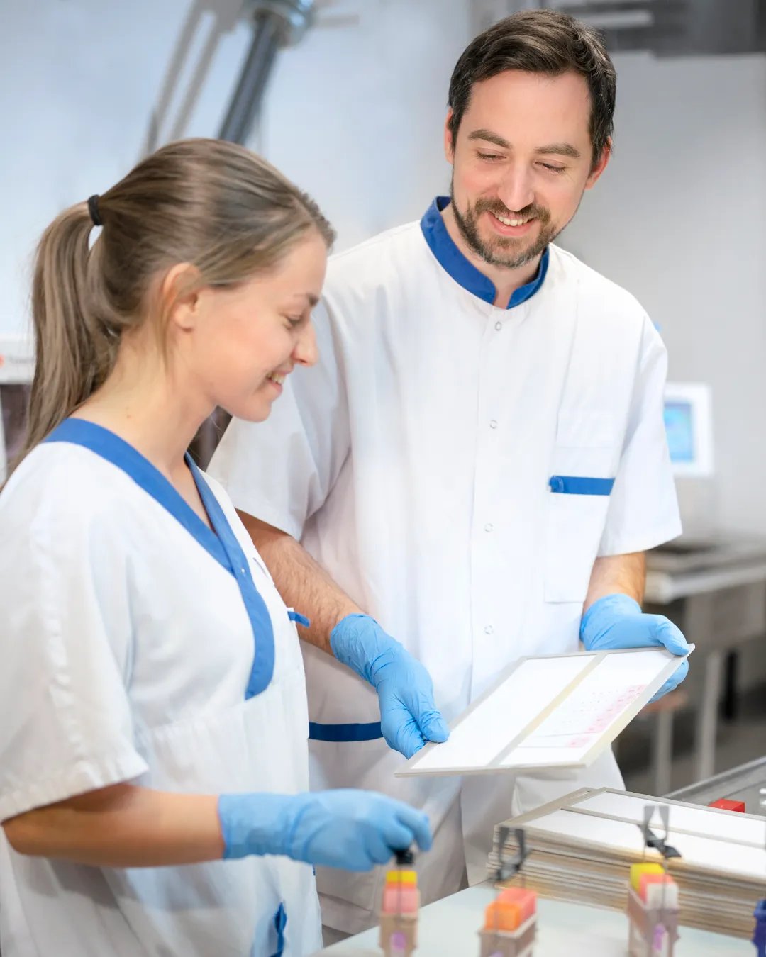 A man and a woman in a lab smiling.