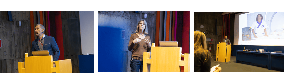 En man och en kvinna står på scen och talar vid podium