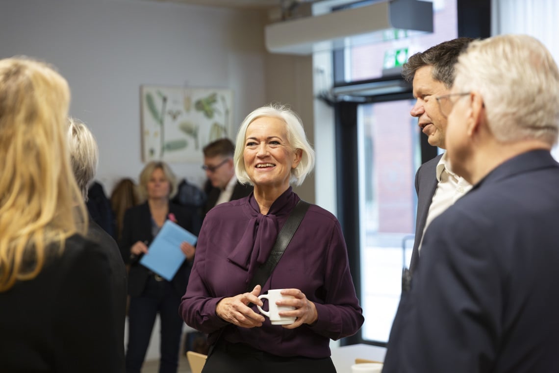 En grupp människor som står och pratar med varandra.