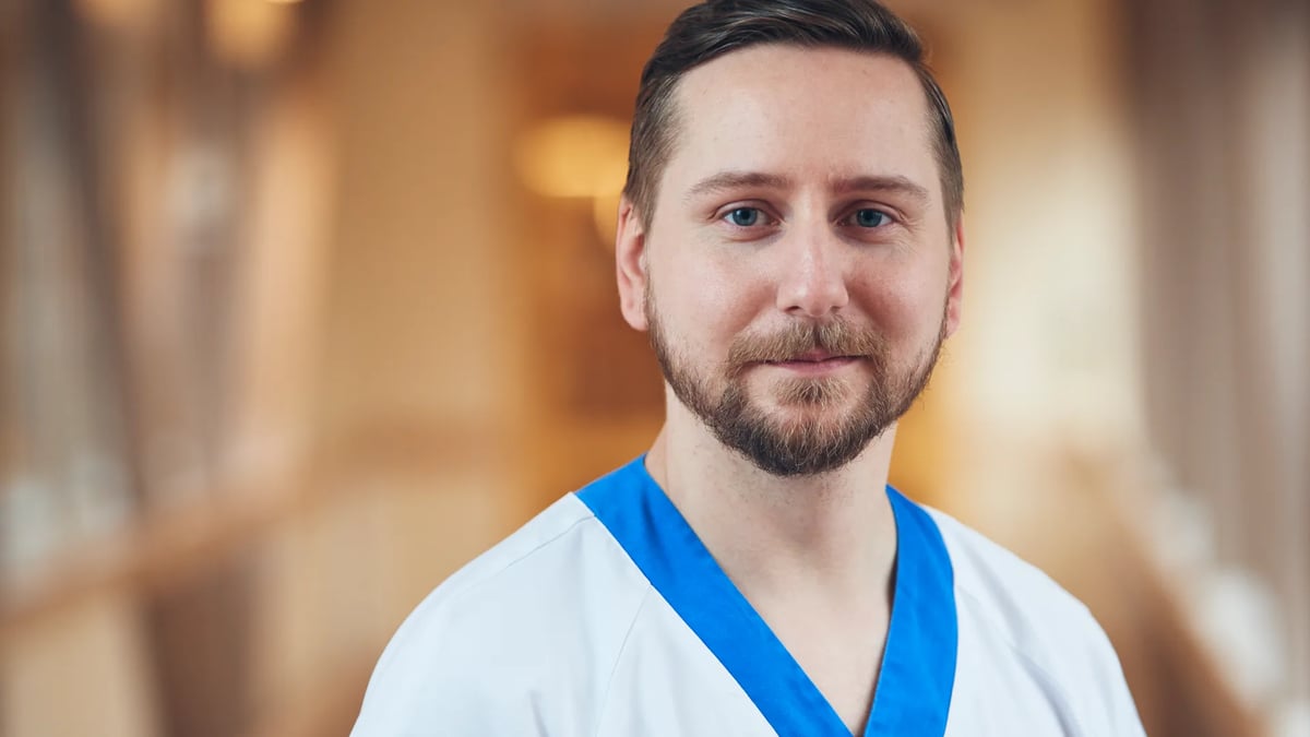 En man i vit skjorta och blå slips.