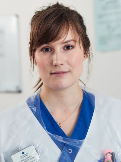 A woman in a white doctor coat.