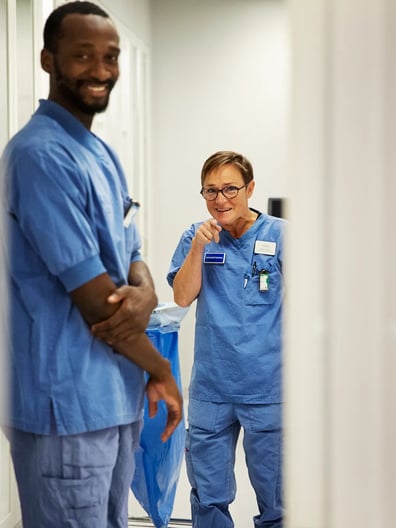 A man and a woman standing in a hallway.