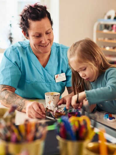 A woman and a little girl sitting at a table.