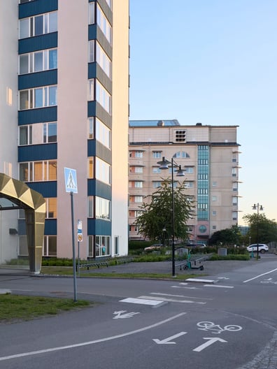 A city street with a tall building in the background.