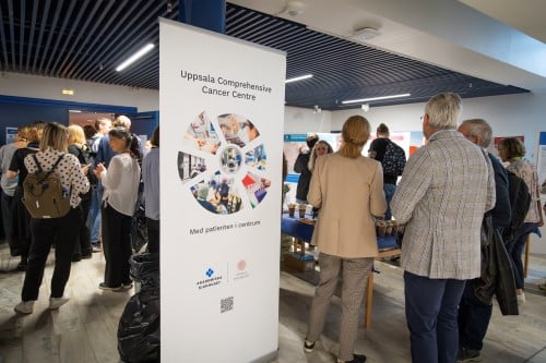 Många personer som står upp och minglar i utställningslokal