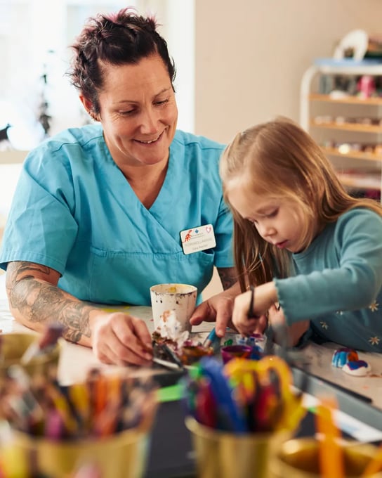 A woman and a little girl sitting at a table.