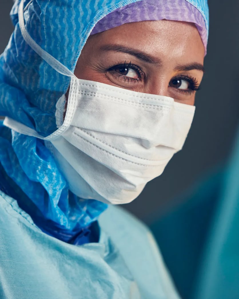 A woman wearing a surgical mask.