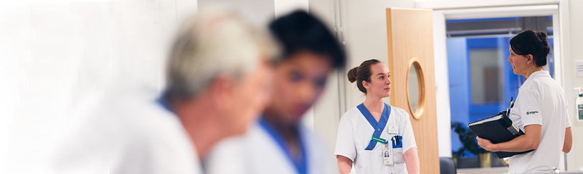 Caregivers talking in corridor.